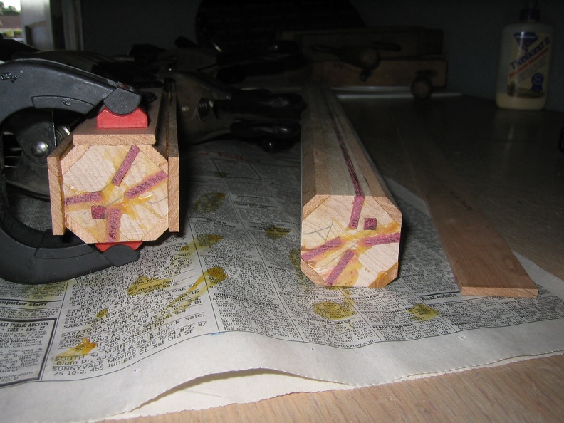 Once the amrs and legs are in and the corners chopped off of the block, I start glueing on the outer band made of cherry.