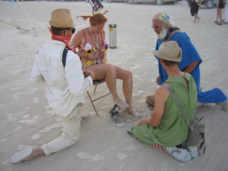 Two guys helped wash her feet, while the third one sang a song with his accordian.