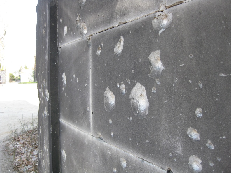 Bullet holes in a cemetery wall